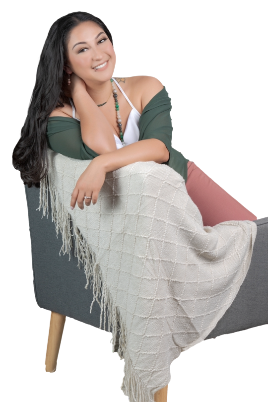 Alt Text Therapist sitting comfortably in a chair with a warm, friendly smile, creating a calm and welcoming presence for clients in Upland, CA.