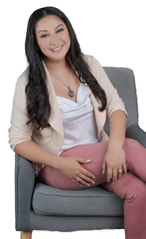 Therapist seated in a chair with a warm, welcoming smile, creating a safe and supportive presence for clients in Upland, CA.